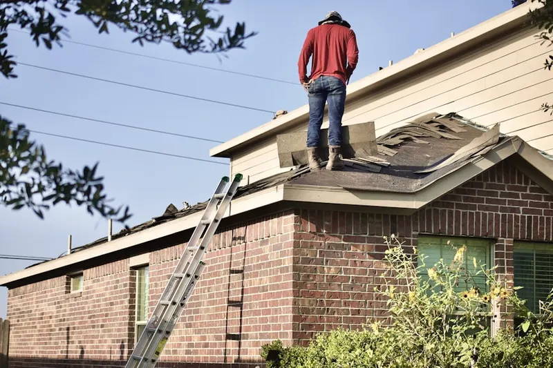 Professional roofer working on a residential roof in Franklin